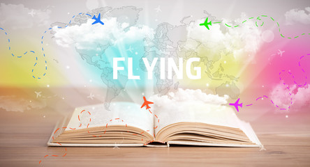 Open book with FLYING inscription, vacation concept