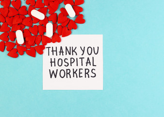 a lot of small red hearts along with medical pills and the inscription Thank you to hospital workers