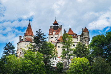 Bran or Dracula Castle in Transylvania, Romania under blue cloudy sky