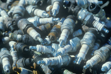 A pile of used spark plugs ready for recycling
