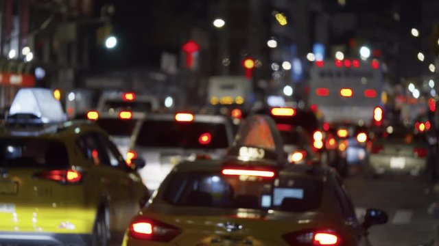 New York City rush hour, heavy street traffic with blurry unrecognizable commuting cars, night time