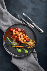 Grilled scallops with vegetables and sauce, a beautiful presentation from the chef, food photo, dark background. copy space, seafood food concept