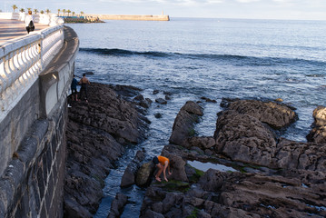 young girl in distress on reef with orange shirt
