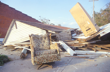 An armchair and a gabled roof in one piece while the rest of a Jeanerette, Louisiana, house lies in...