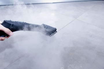 cleaning the floor of the house with a steam cleaner, disinfection of the room.