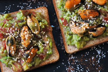 Guacamole toasts with mussels. Healthy snack. Keto diet.