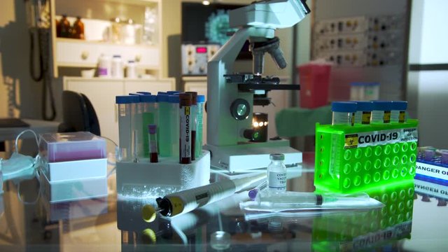 Scene tracks around a laboratory scene with various types of equipment and paraphernalia used to research a vaccine for the coronavirus COVID19.