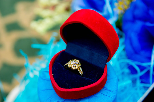 A Flower Shape Diamond Ring Inside A Case