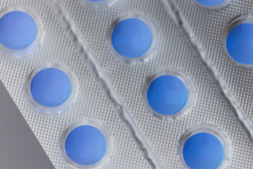 Blister with blue vitamins or pills, macro photo