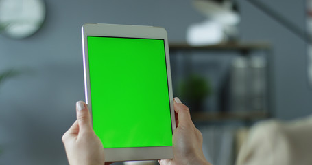 Closeup of woman hands holding digital tablet with blank screen