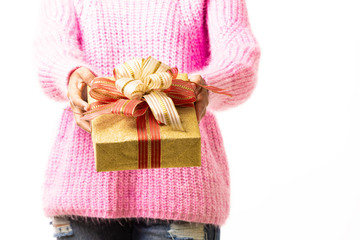 Women wearing pink sweaters and holding gold color gift box on a white background.