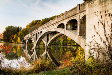 Abandoned bridge reflected into Lake Ontelaunee in autumn