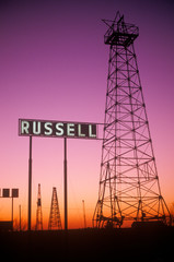 Obsolete oil rigs at sunset, Russell, KS