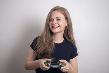 Smiling young caucasian woman girl holding joystick game pad controller, playing computer game.