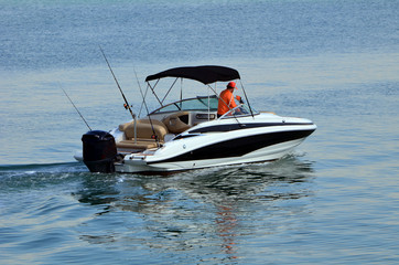Upscale motor boat powered by a single outboard engine.