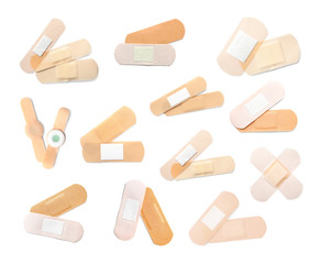 Set with sticking plasters on white background, top view
