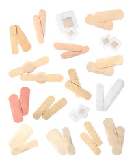 Set with different sticking plasters on white background, top view