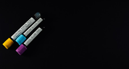 Isolated Covid-19 laboratory blood test tubes. Black background, medical health care concept, top view, corona virus prevention and treatment.