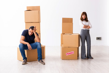 Young pair and many boxes in divorce settlement concept