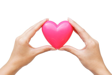 Obraz na płótnie Canvas Female hand holding a pink heart isolated on white background