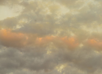 Beautiful puffy clouds at sunset isolated against pastel blue skies