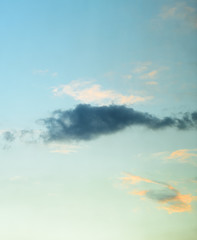 Beautiful puffy clouds at sunset isolated against pastel blue skies