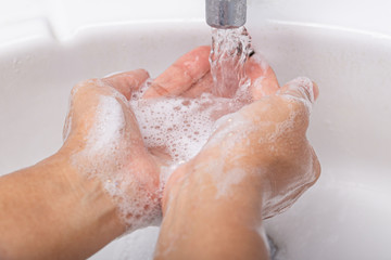 Fototapeta premium Washing thoroughly your hands with water and soap
