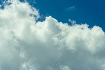 Beautiful puffy clouds at sunset isolated against pastel blue skies