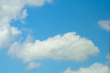 Beautiful puffy clouds at sunset isolated against pastel blue skies
