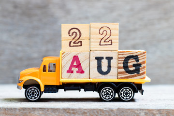 Truck hold letter block in word 22aug on wood background (Concept for date 22 month August)