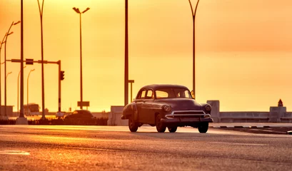 Keuken spatwand met foto old classic american car driving though the streets of havana in cuba with the malecon in the background © javier