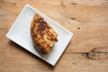 omelette with ham and peppers on wooden background