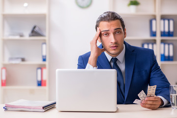 Young male employee and a lot of pills on the desk