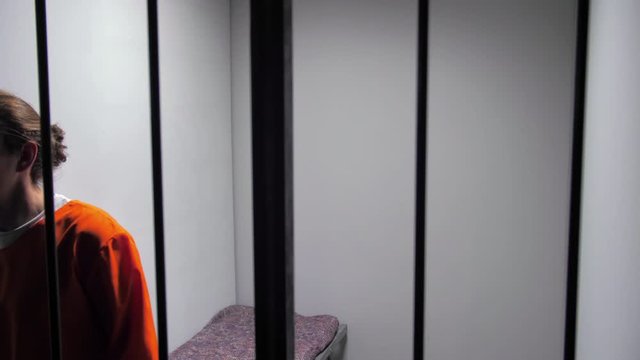 Prisoner walks in a circle in a prison cell