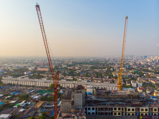 Fototapeta na wymiar Construction site building with crane high rise condominium sunset light