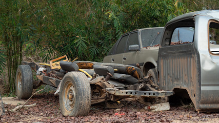 Car wreckage that is rusty and very old On outdoor ground