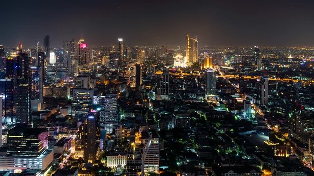 Bangkok business district city center, with buildings and skyscrapers, rush hour traffic, at night, zoom in – Time Lapse