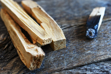 A close up image of palo santo smudge sticks used for energy clearing and healing. 