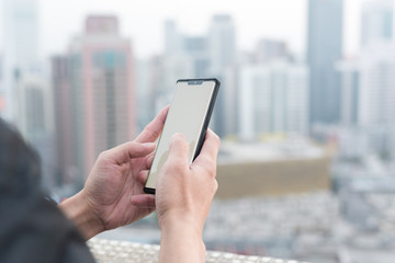 In modern cities, men hold smartphones in their hands