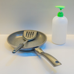 Coronavirus hand sanitizer gel for hand hygiene corona virus protection. stay home concept with a pan and spatula