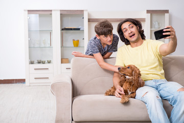 Young father and his son with cocker spaniel dog