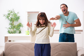 Young couple and snake in the flat