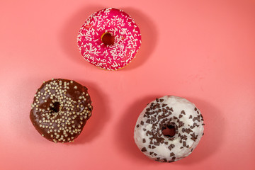 Tasty donuts on pink background. Top view
