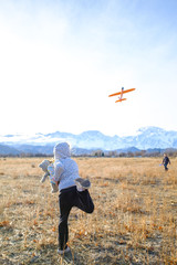 Girl Throwing Glider Plane