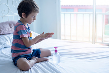 Cute caucasian boy rubbing her hand. he washed his hands with sanitizer gel, prevention for Coronavirus