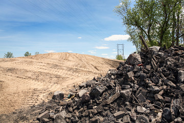 Land prepared for development with trash and debris in a pile in the foreground