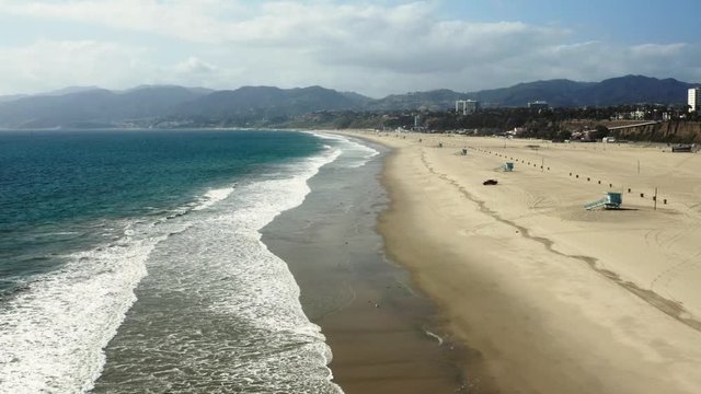 Quarantine in Los Angeles, aerial shot of Venice beach, deserted ocean coast, pandemic situation, empty city
