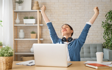 Woman working on a laptop.