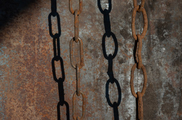 Old rusty iron chain on metal background