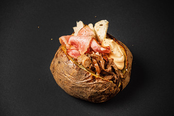 Jacket potato on the black background